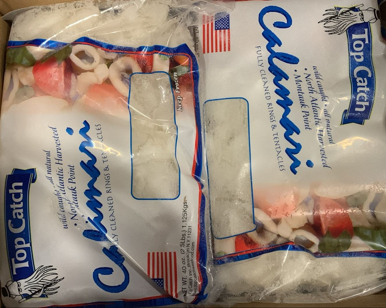 Packaged fish product with 'Top Catch' and 'Calimari' branding inside a cardboard box.