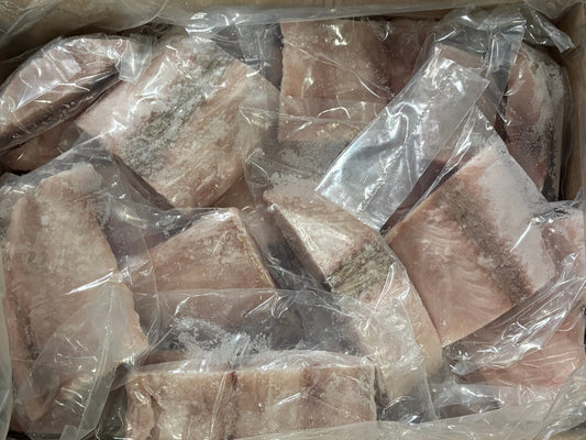Frozen fish fillets in clear plastic bags, stacked inside a cardboard container.