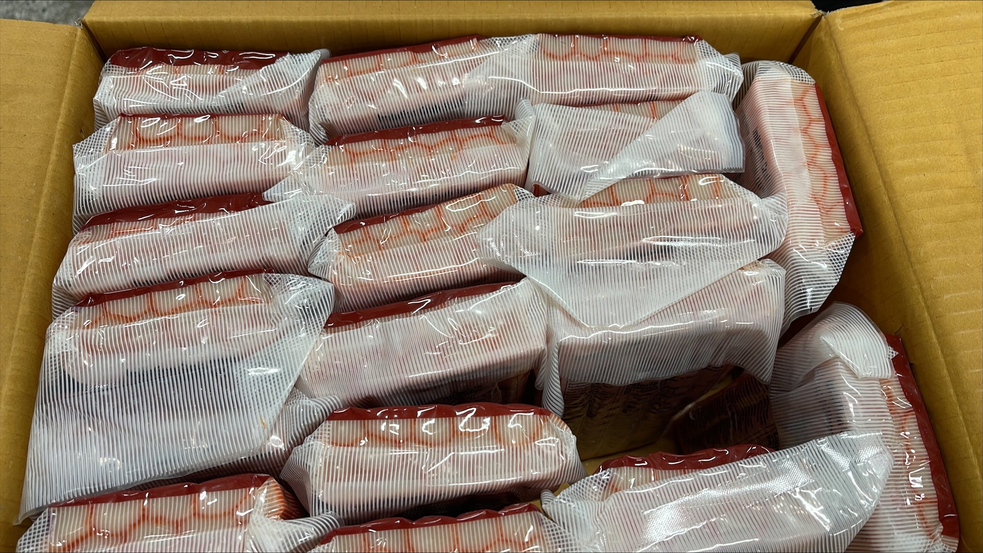 packaged crabsticks in a cardboard box.
